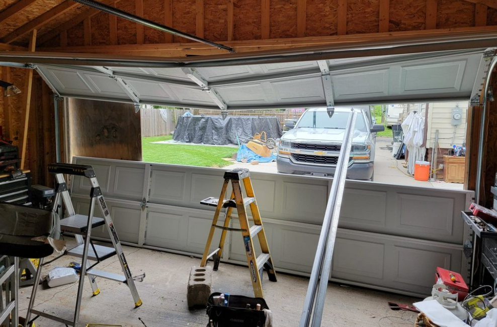 a technician repairing an overhead garage door in Parkland, FL, highlighting the precision and expertise of Parkland FL Garage Door Repair Services.