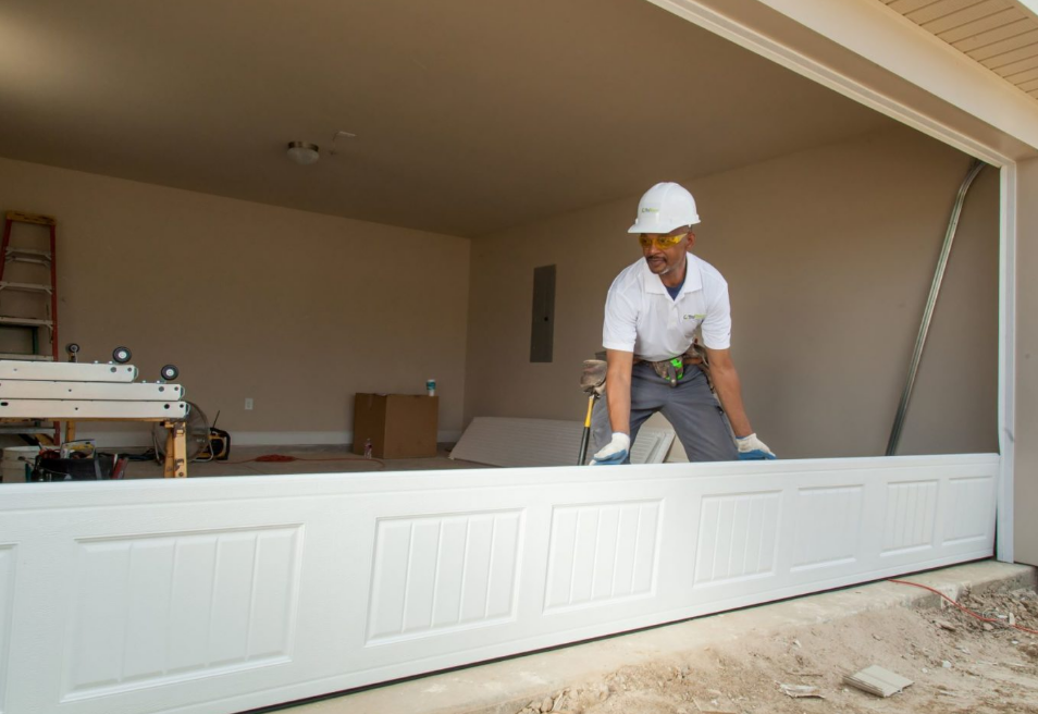Close-up of a professional technician performing garage door panel repair in Parkland, FL, highlighting expertise in fixing damaged panels efficiently.