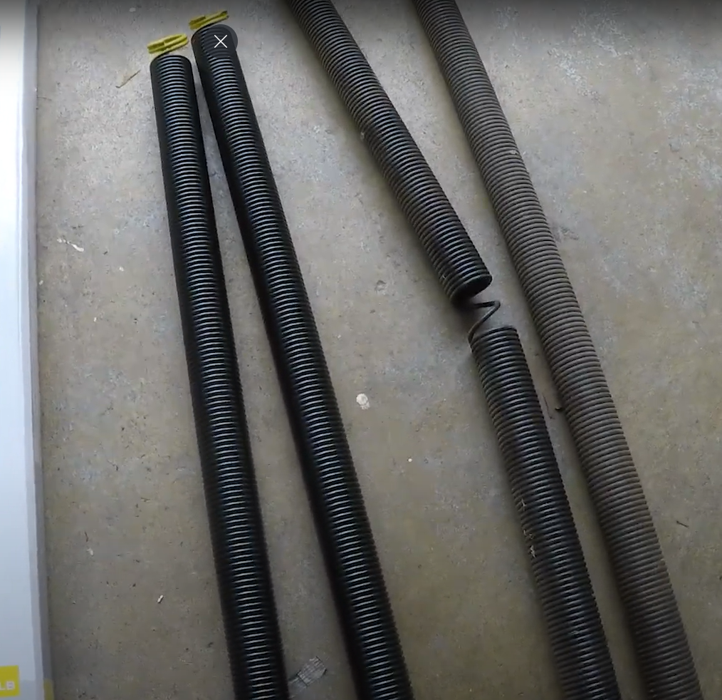 A technician performing garage door spring repair in Parkland, FL, ensuring smooth and safe door operation for residential clients.