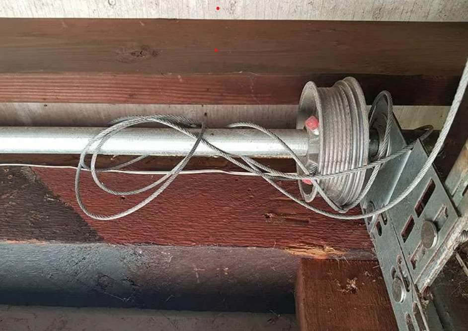 Technician performing arage door cable repair in Parkland, ensuring safe and efficient garage door operation for residents."