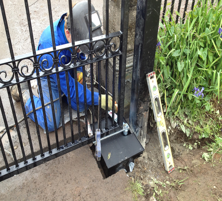 a professional technician repairing a residential gate in Parkland, FL, highlighting the high-quality gate repair services provided by Parkland FL Garage Door Repair Services.