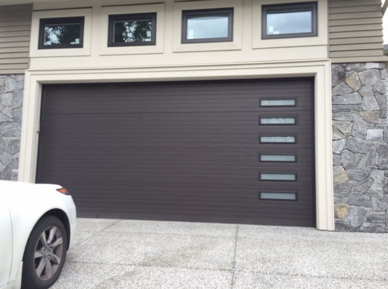 Technician providing local garage door repair services in Parkland, FL, ensuring safety and functionality.