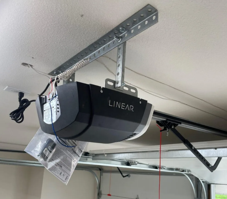 a technician in Parkland, FL inspecting a garage door opener for repair services, showcasing reliable and professional garage door solutions.