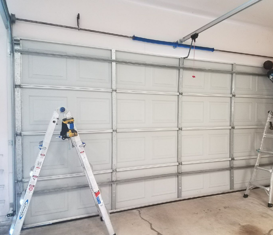professional garage door installation service being performed on a residential property in Parkland, FL by an expert technician from Parkland FL Garage Door Repair Services.